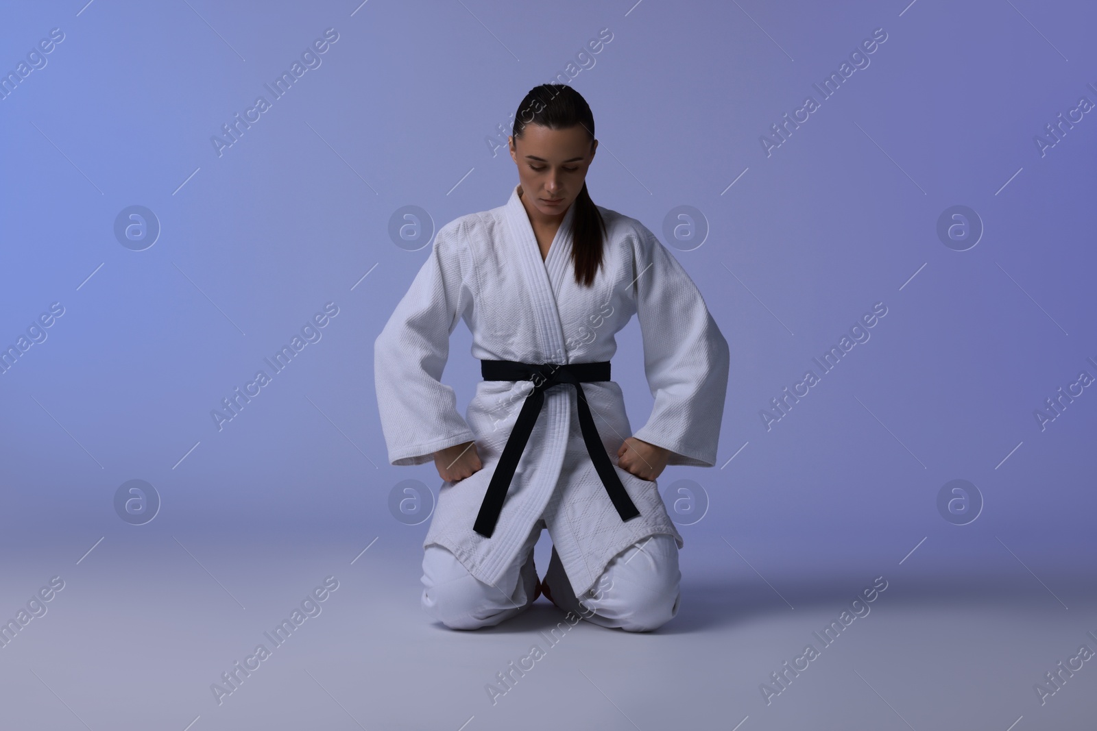 Photo of Karate fighter in kimono on light background