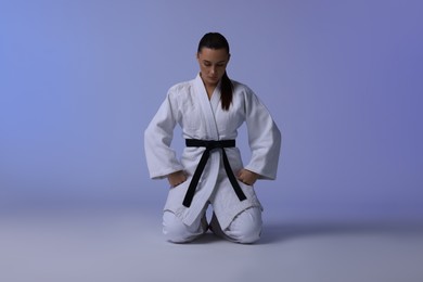 Photo of Karate fighter in kimono on light background