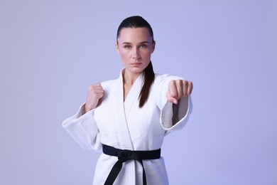 Photo of Karate fighter in kimono on light background