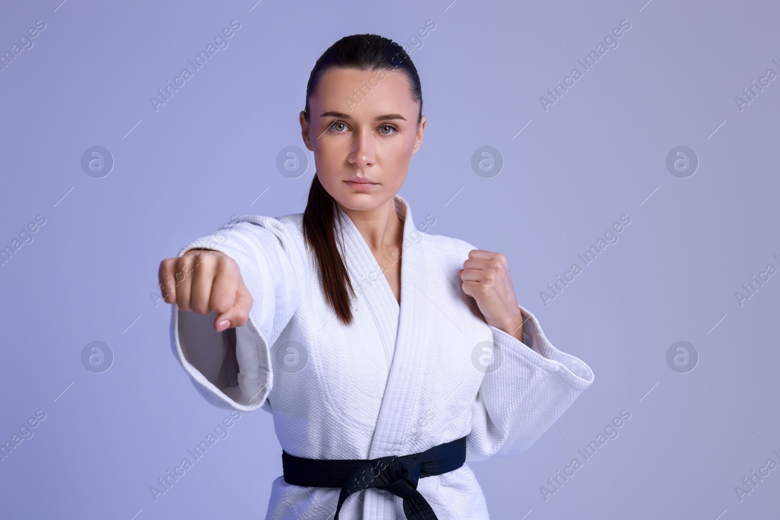 Photo of Karate fighter in kimono on light background