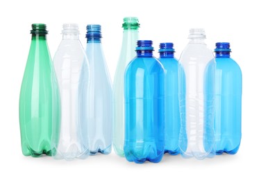 Photo of Many empty plastic bottles isolated on white