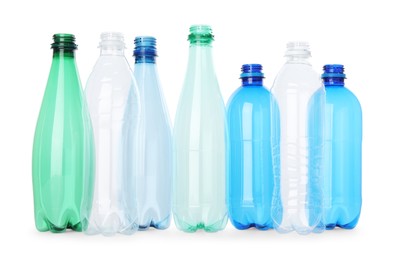 Photo of Many empty plastic bottles isolated on white