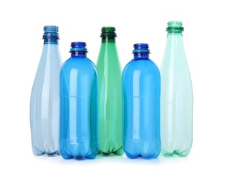 Photo of Many empty plastic bottles isolated on white