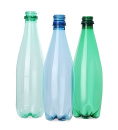 Photo of Many empty plastic bottles isolated on white