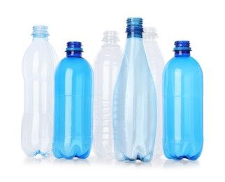 Photo of Many empty plastic bottles isolated on white