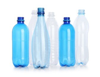 Photo of Many empty plastic bottles isolated on white