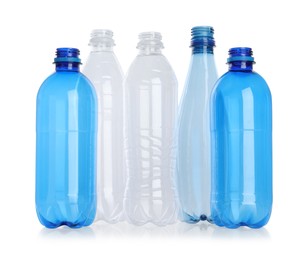 Photo of Many empty plastic bottles isolated on white