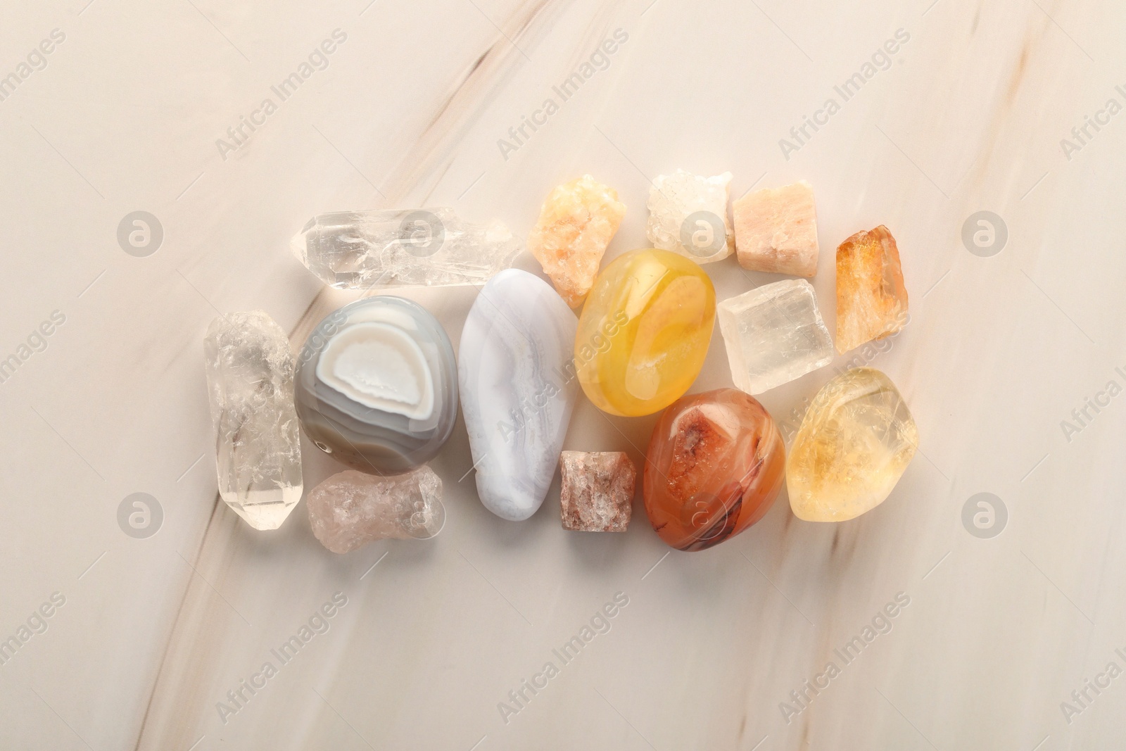 Photo of Beautiful natural gemstones on light background, flat lay