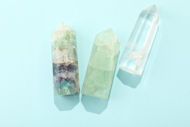 Photo of Beautiful natural gemstones on light blue background, flat lay