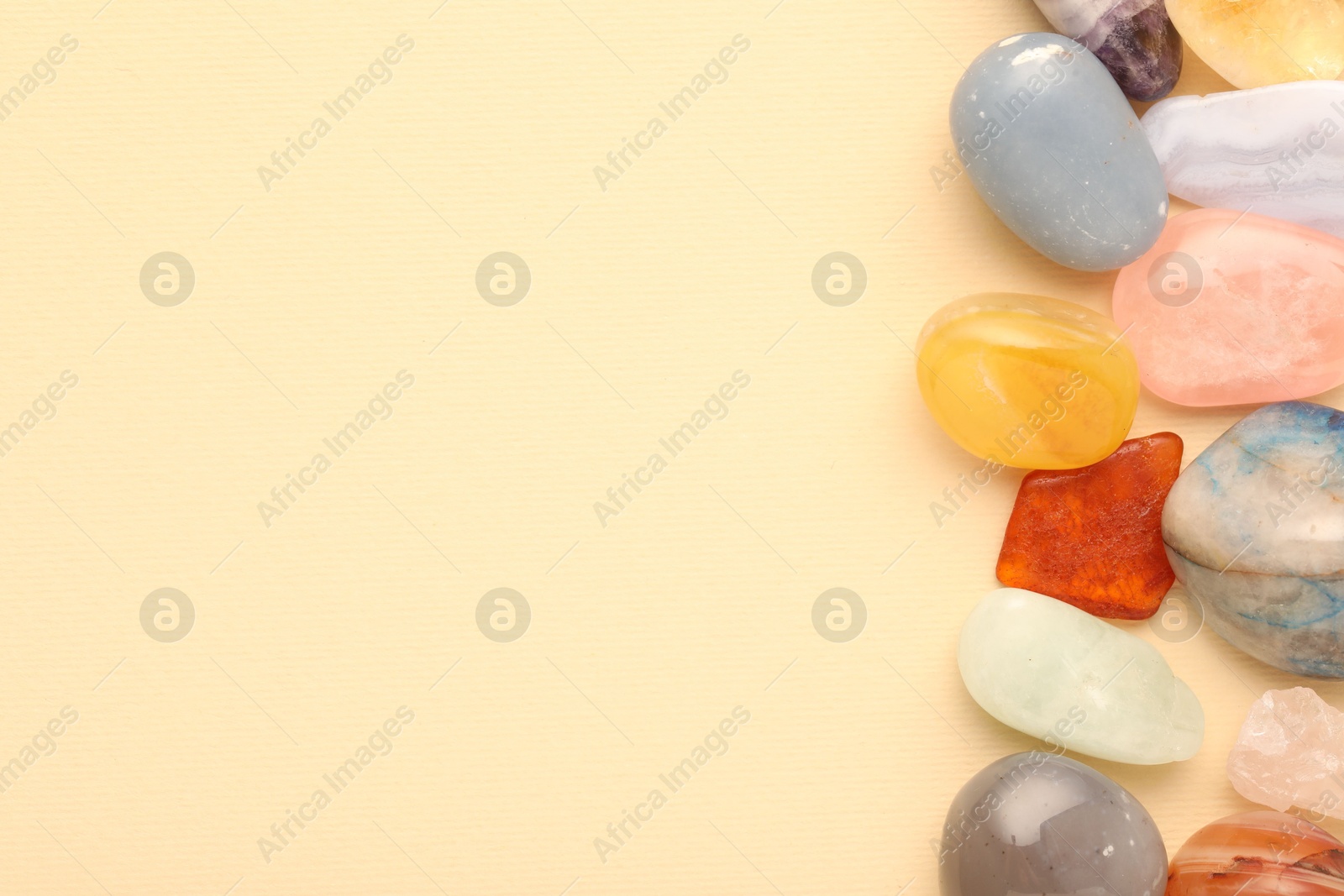 Photo of Beautiful natural gemstones on beige background, flat lay. Space for text