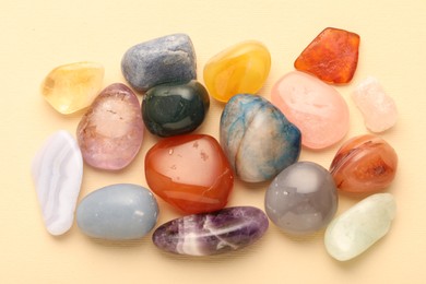 Photo of Beautiful natural gemstones on beige background, flat lay