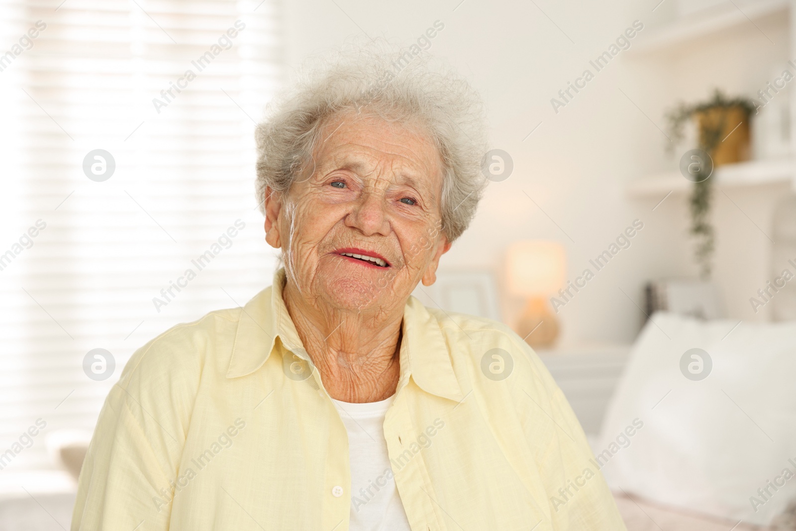 Photo of Portrait of smiling senior woman at home