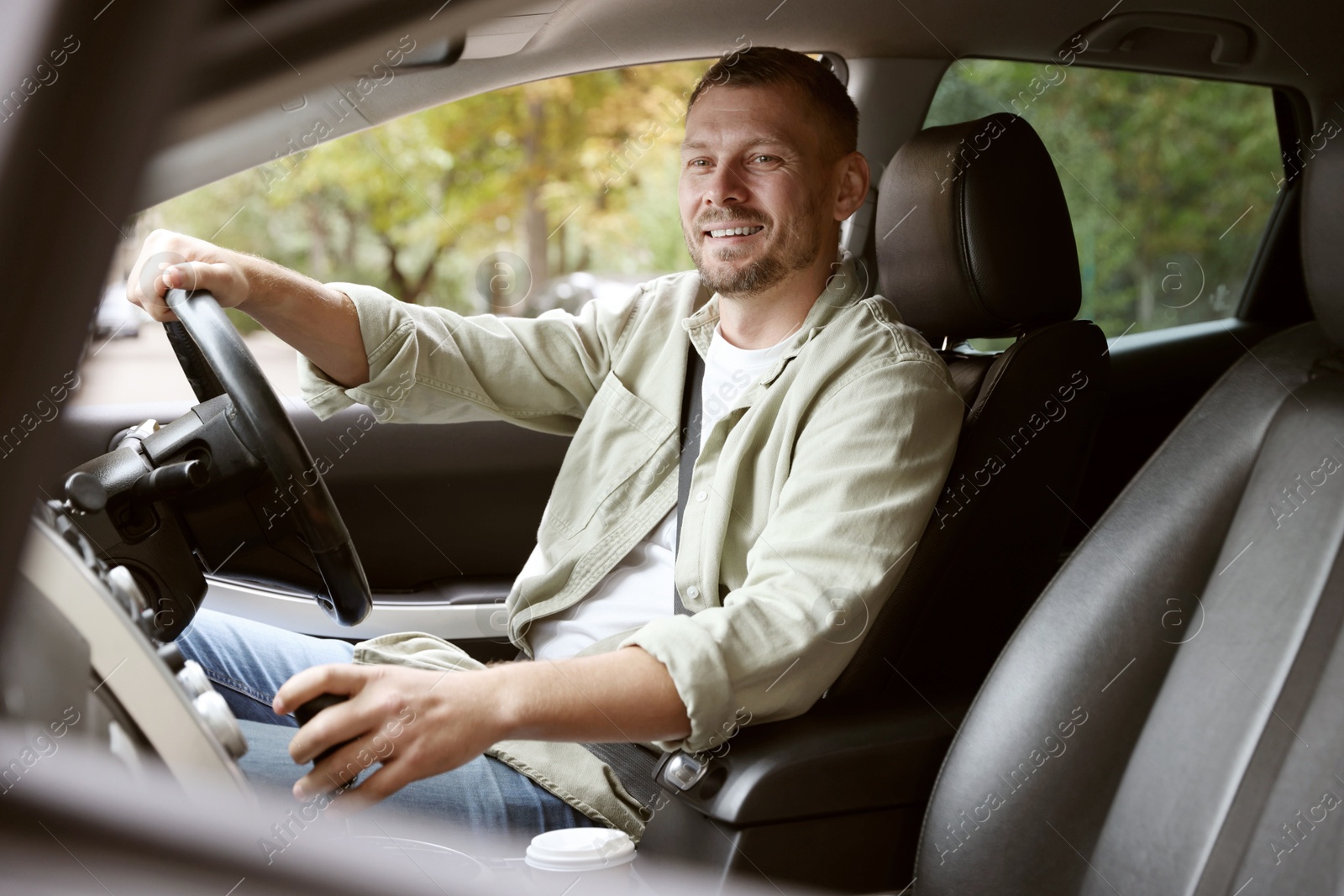 Photo of Man driving modern car, view through window