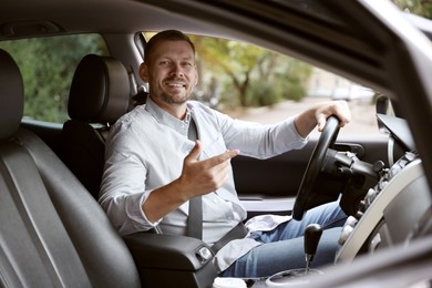 Photo of Man driving modern car, view through window