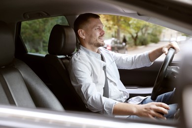 Photo of Man driving modern car, view through window