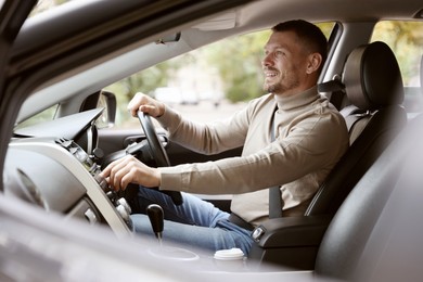 Photo of Man driving modern car, view through window