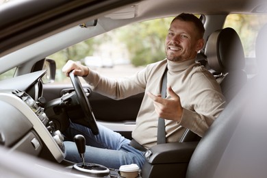 Photo of Man driving modern car, view through window