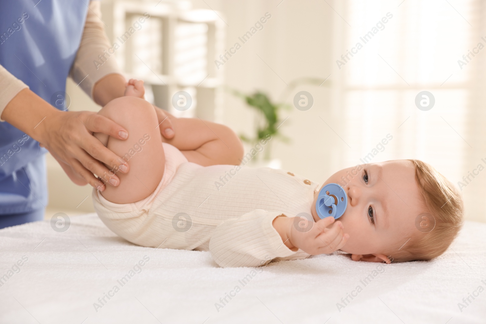 Photo of Pediatrician with little child in clinic, closeup. Checking baby's health