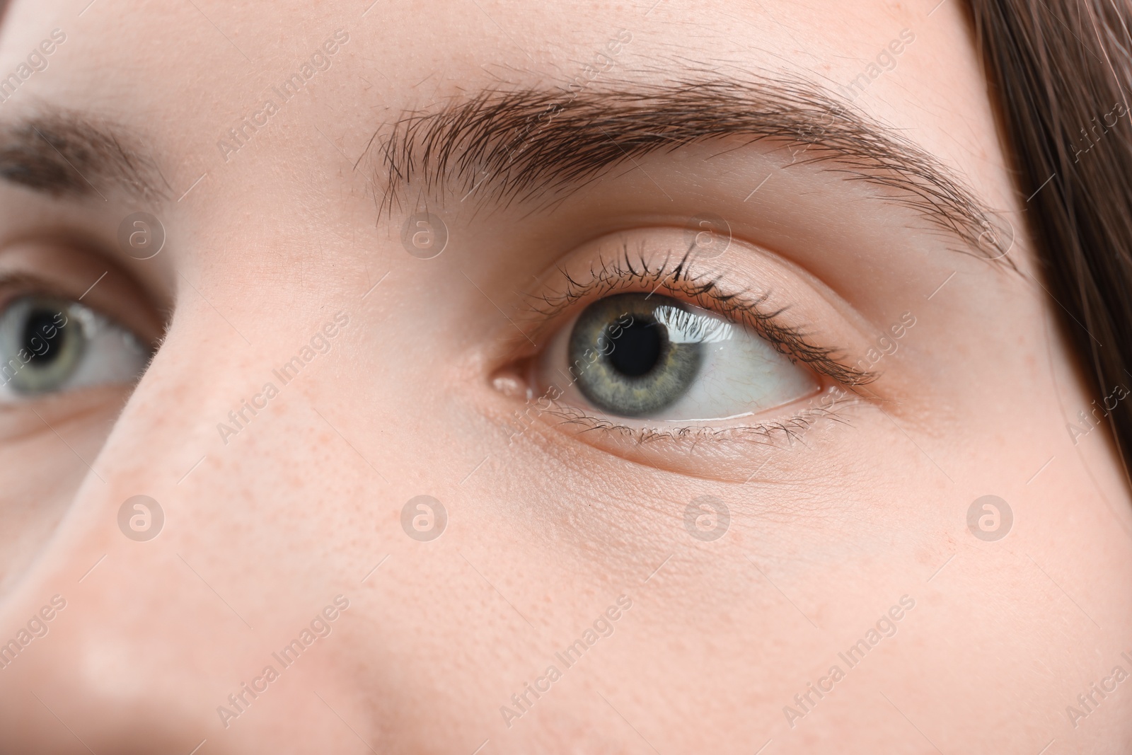 Photo of Closeup view of young woman with beautiful blue eyes