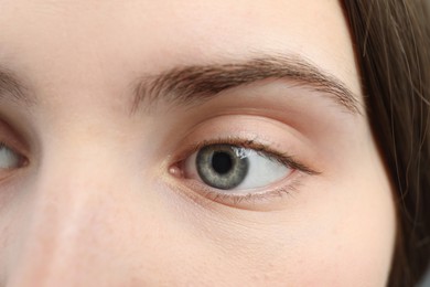 Photo of Closeup view of young woman with beautiful blue eyes