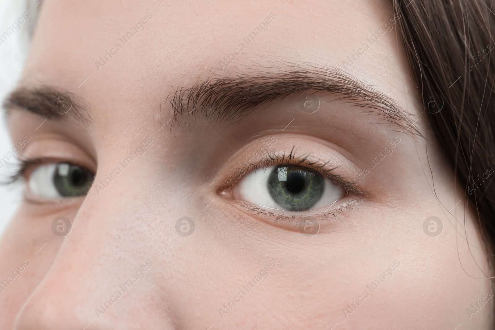 Photo of Closeup view of young woman with beautiful blue eyes