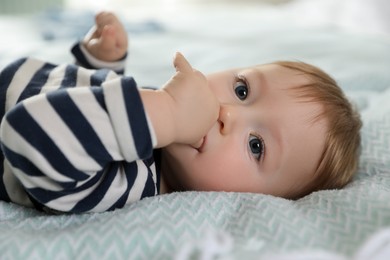 Photo of Cute little baby on bed at home