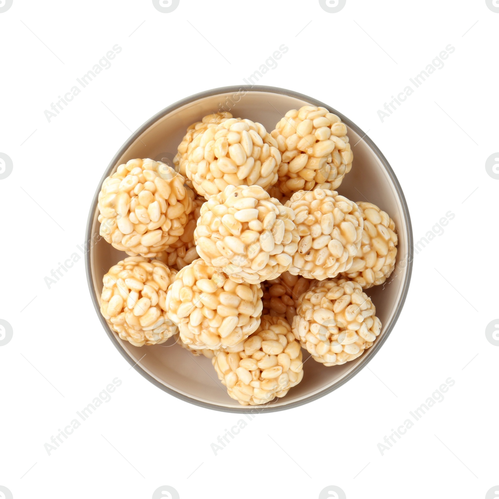 Photo of Delicious puffed rice balls in bowl isolated on white, top view