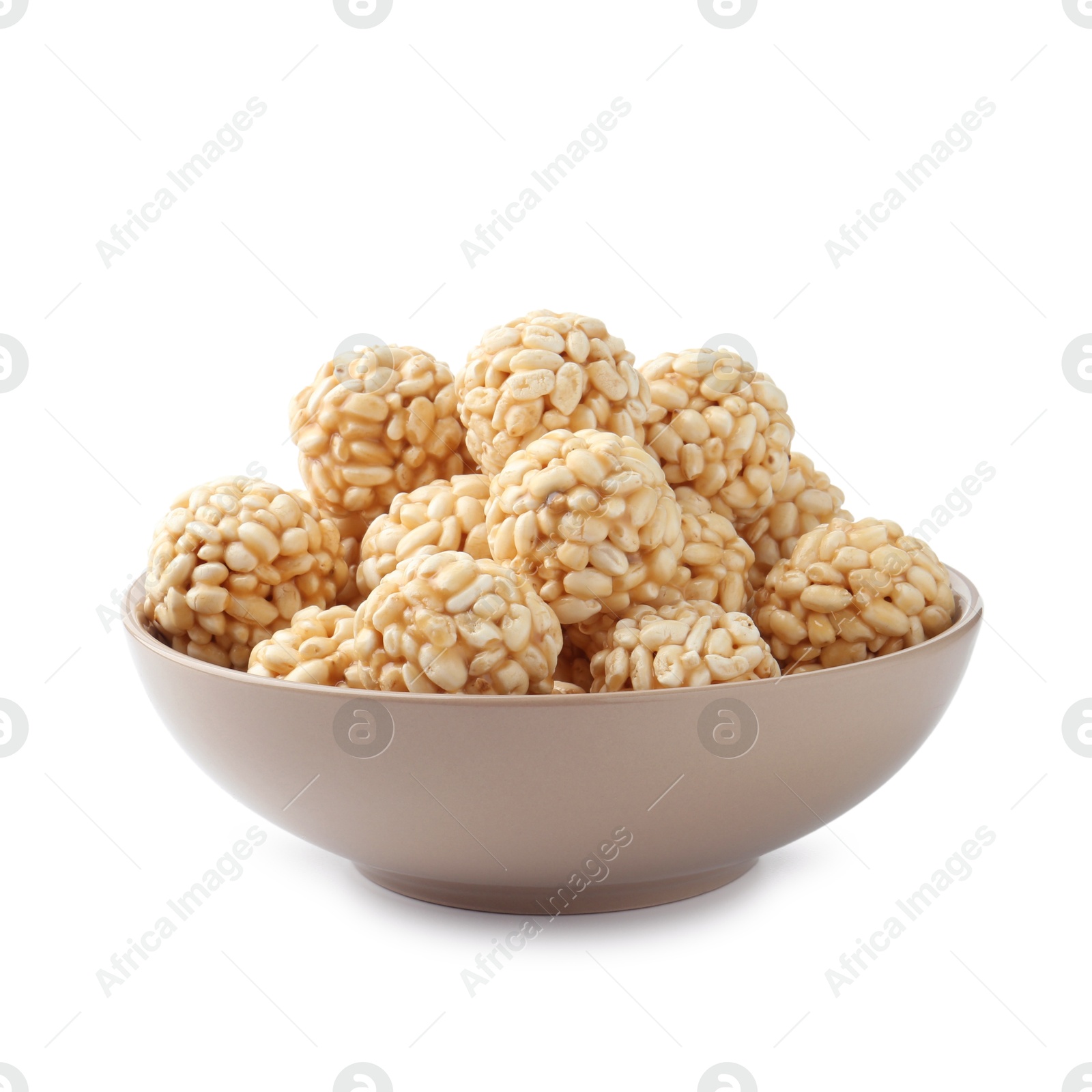 Photo of Delicious puffed rice balls in bowl isolated on white