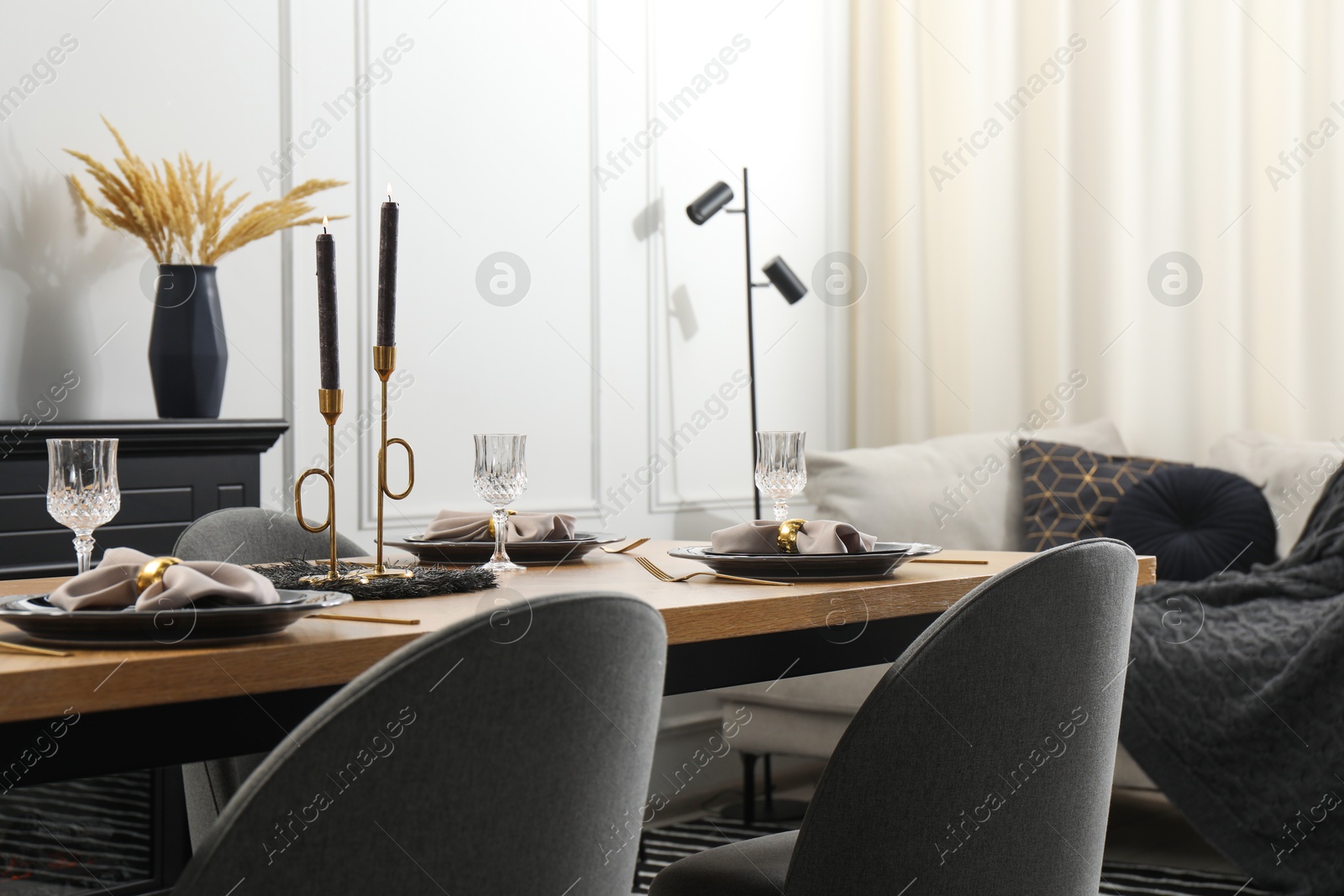 Photo of Stylish table setting with black dishware in dining room