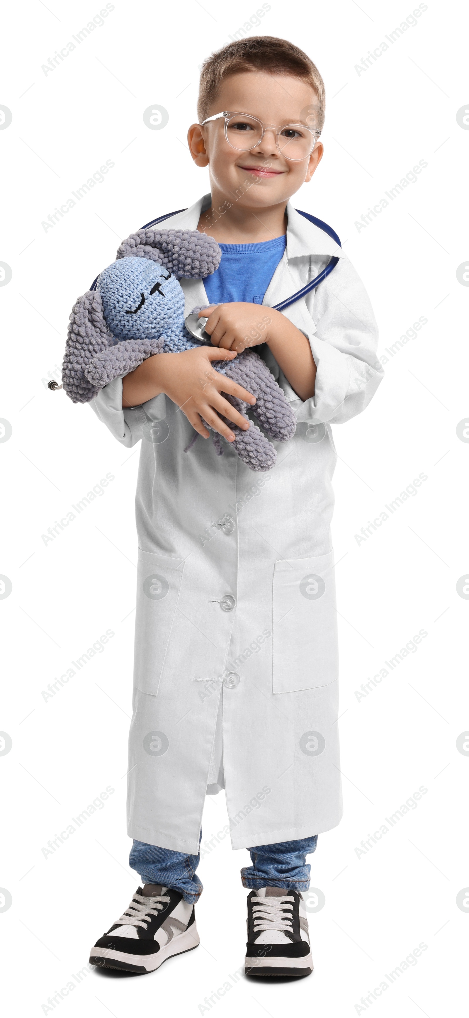 Photo of Little boy with stethoscope and toy pretending to be doctor on white background. Dreaming of future profession