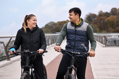 Photo of Beautiful happy couple with bicycles spending time together outdoors