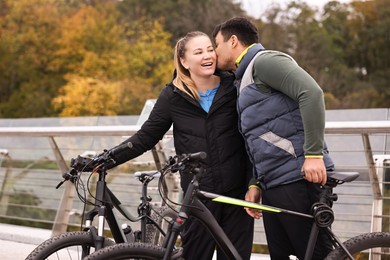 Photo of Beautiful happy couple with bicycles spending time together outdoors