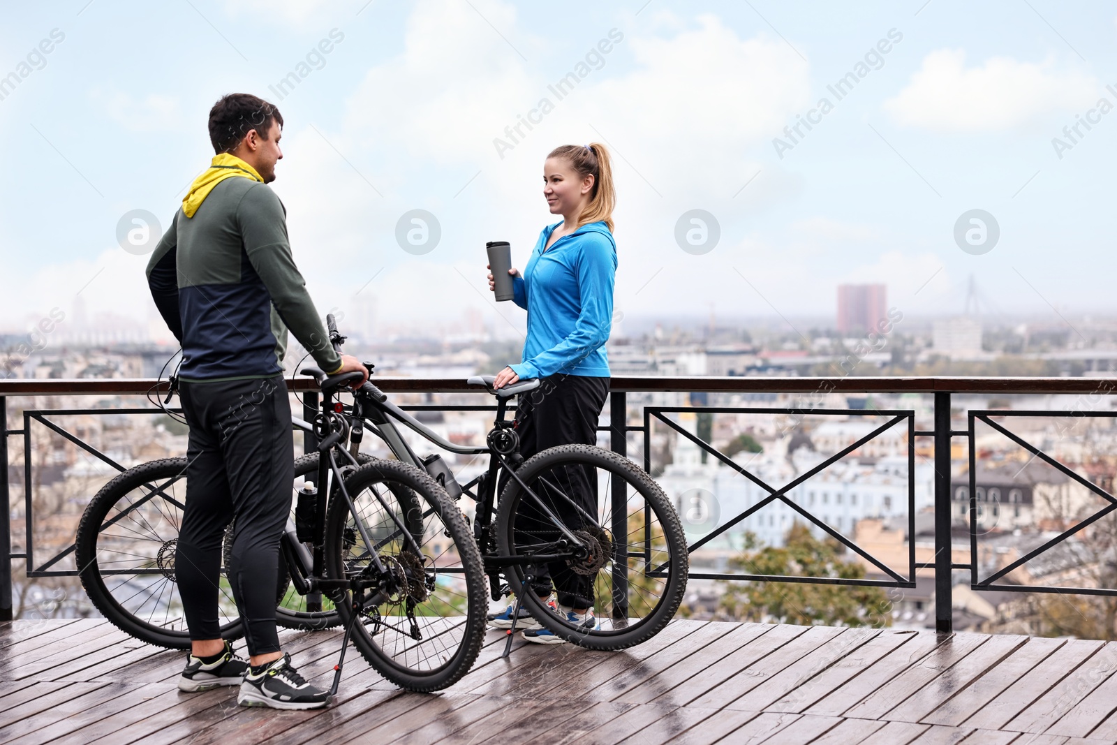 Photo of Beautiful happy couple with bicycles spending time together outdoors