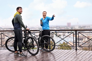 Photo of Beautiful happy couple with bicycles spending time together outdoors