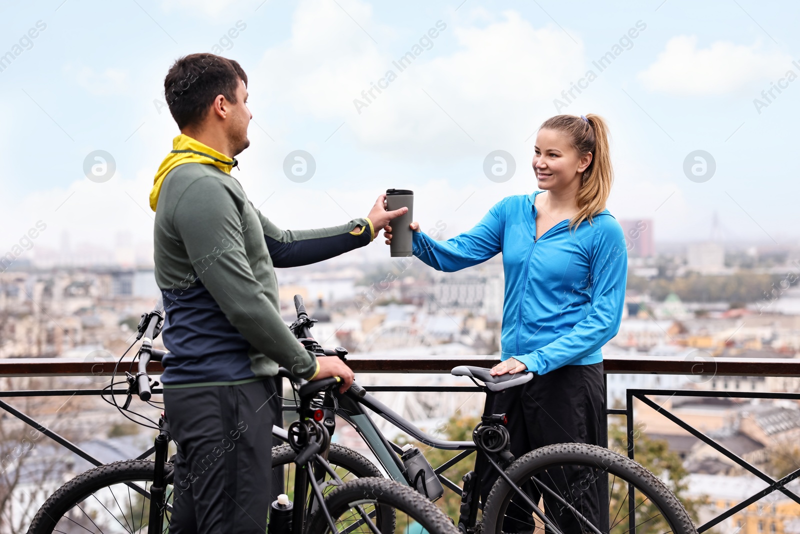 Photo of Beautiful happy couple with bicycles spending time together outdoors