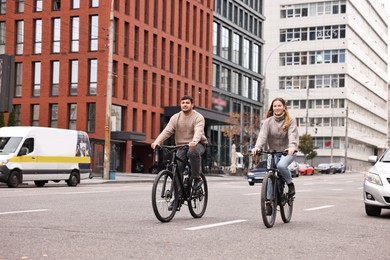 Photo of Beautiful happy couple riding bicycles and spending time together outdoors