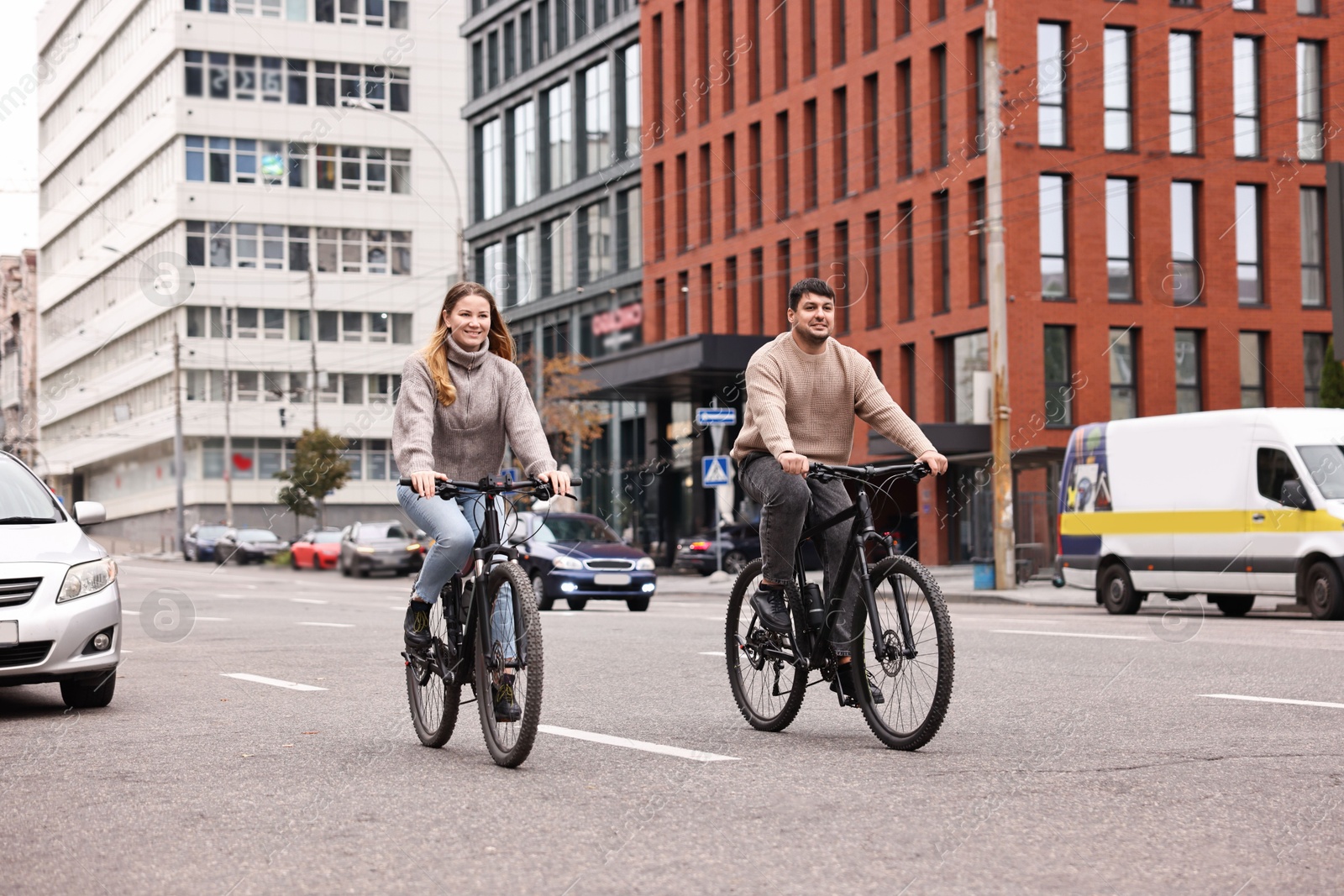 Photo of Beautiful happy couple riding bicycles and spending time together outdoors