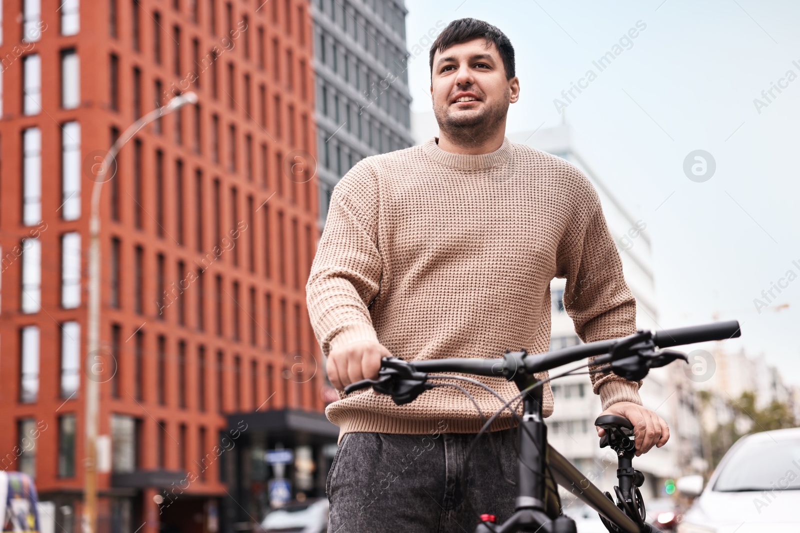 Photo of Man with bicycle outdoors, low angle view. Space for text