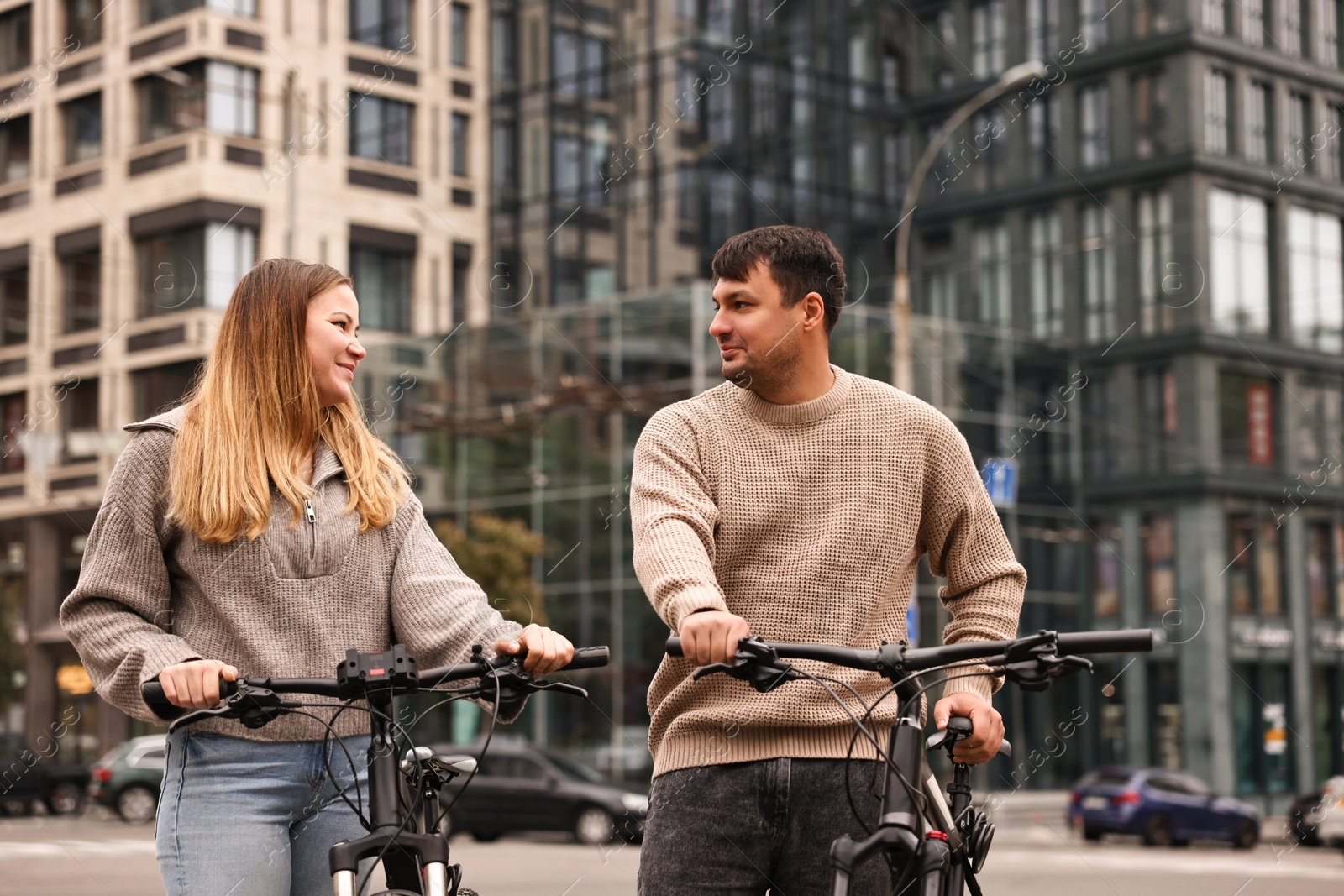 Photo of Beautiful happy couple with bicycles spending time together outdoors