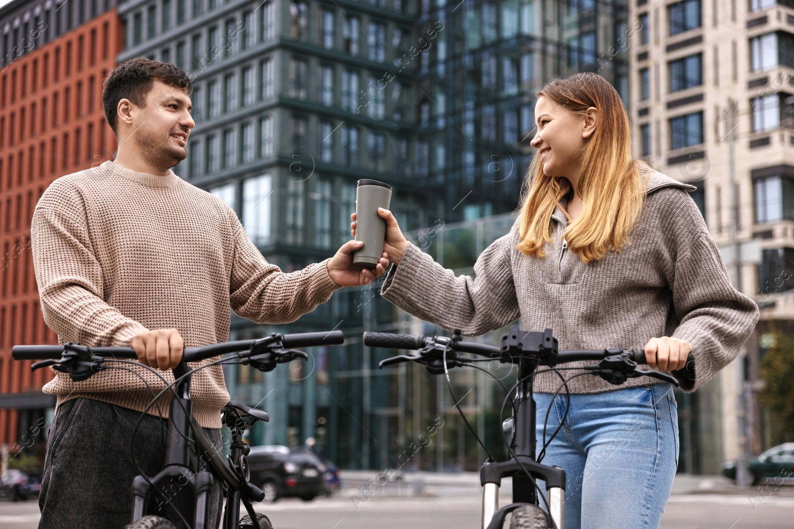 Photo of Beautiful happy couple with bicycles spending time together outdoors