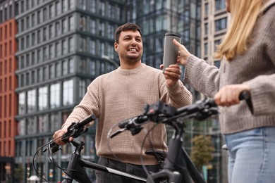 Photo of Beautiful happy couple with bicycles spending time together outdoors