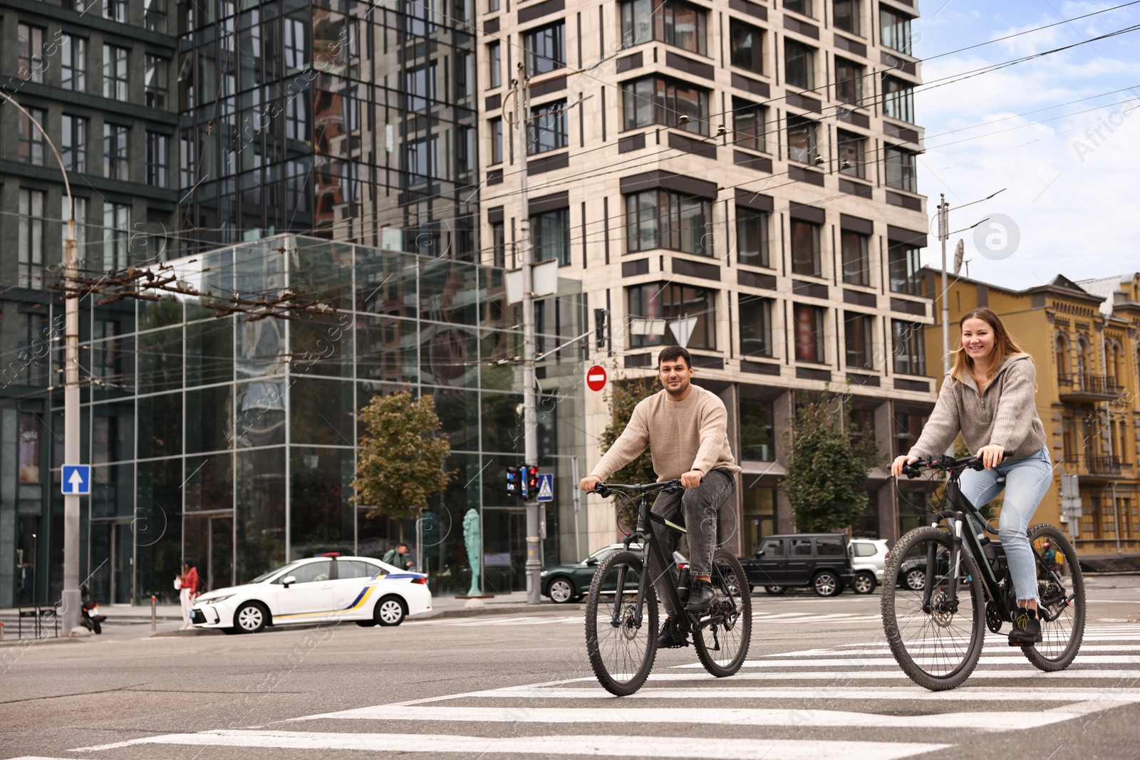 Photo of Beautiful happy couple riding bicycles and spending time together outdoors