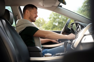 Photo of Man driving modern car, view through window