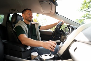 Photo of Man driving modern car, low angle view