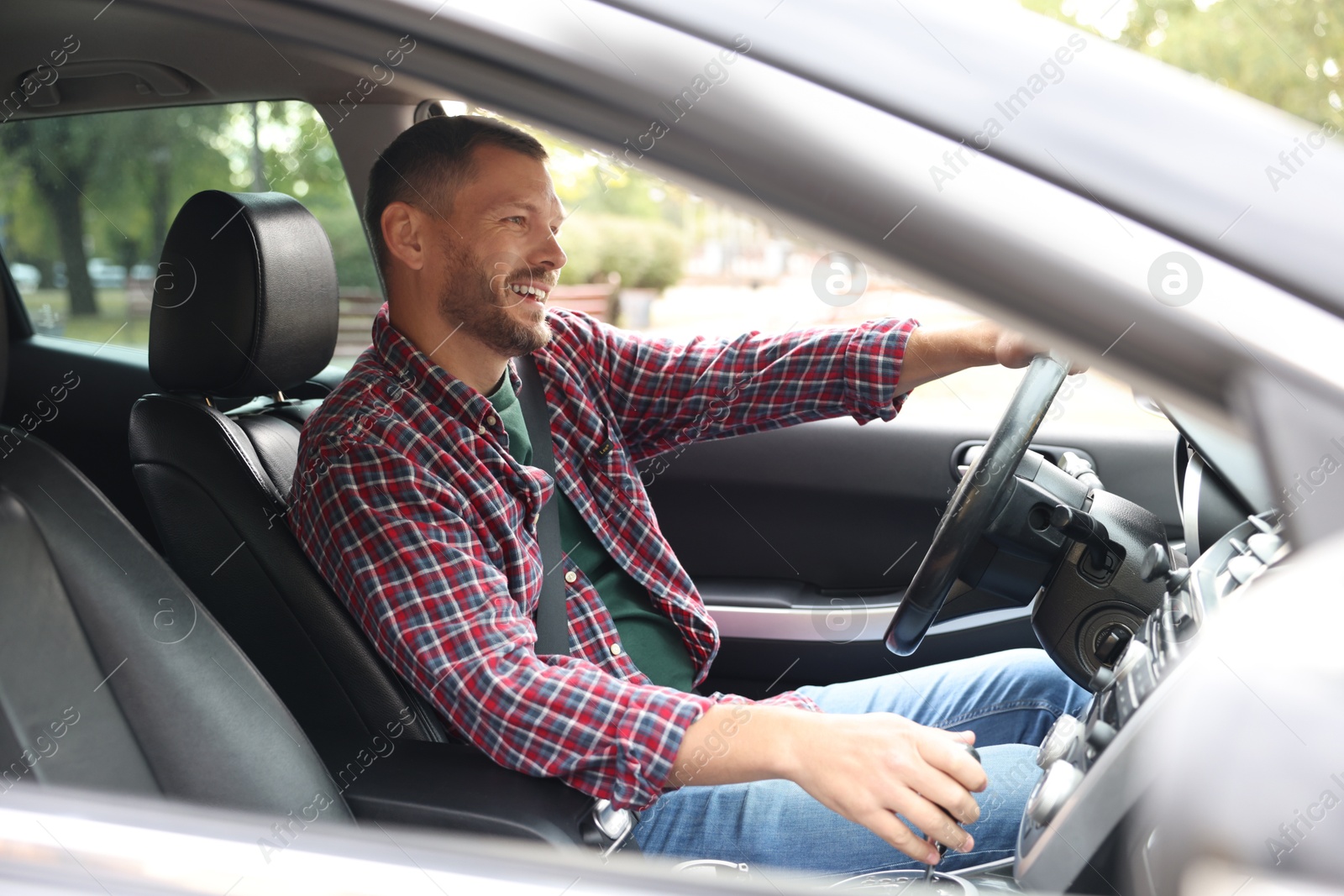 Photo of Man driving modern car, view through window