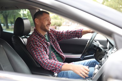 Photo of Man driving modern car, view through window