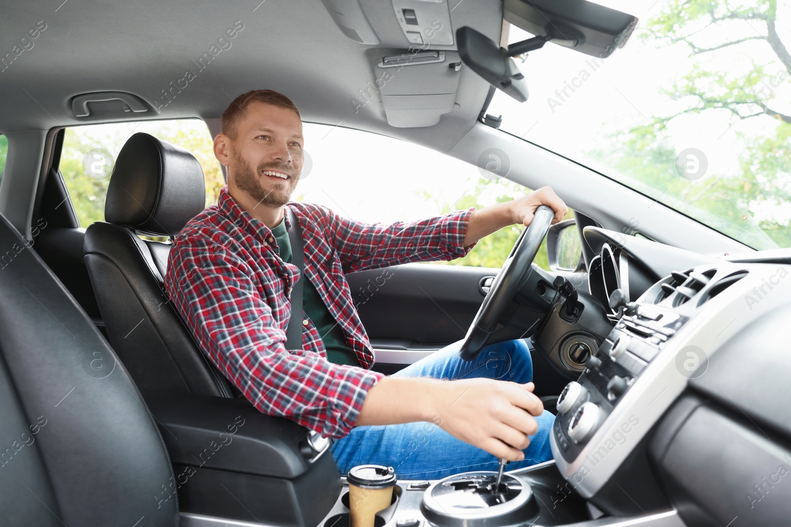 Photo of Man driving modern car, low angle view