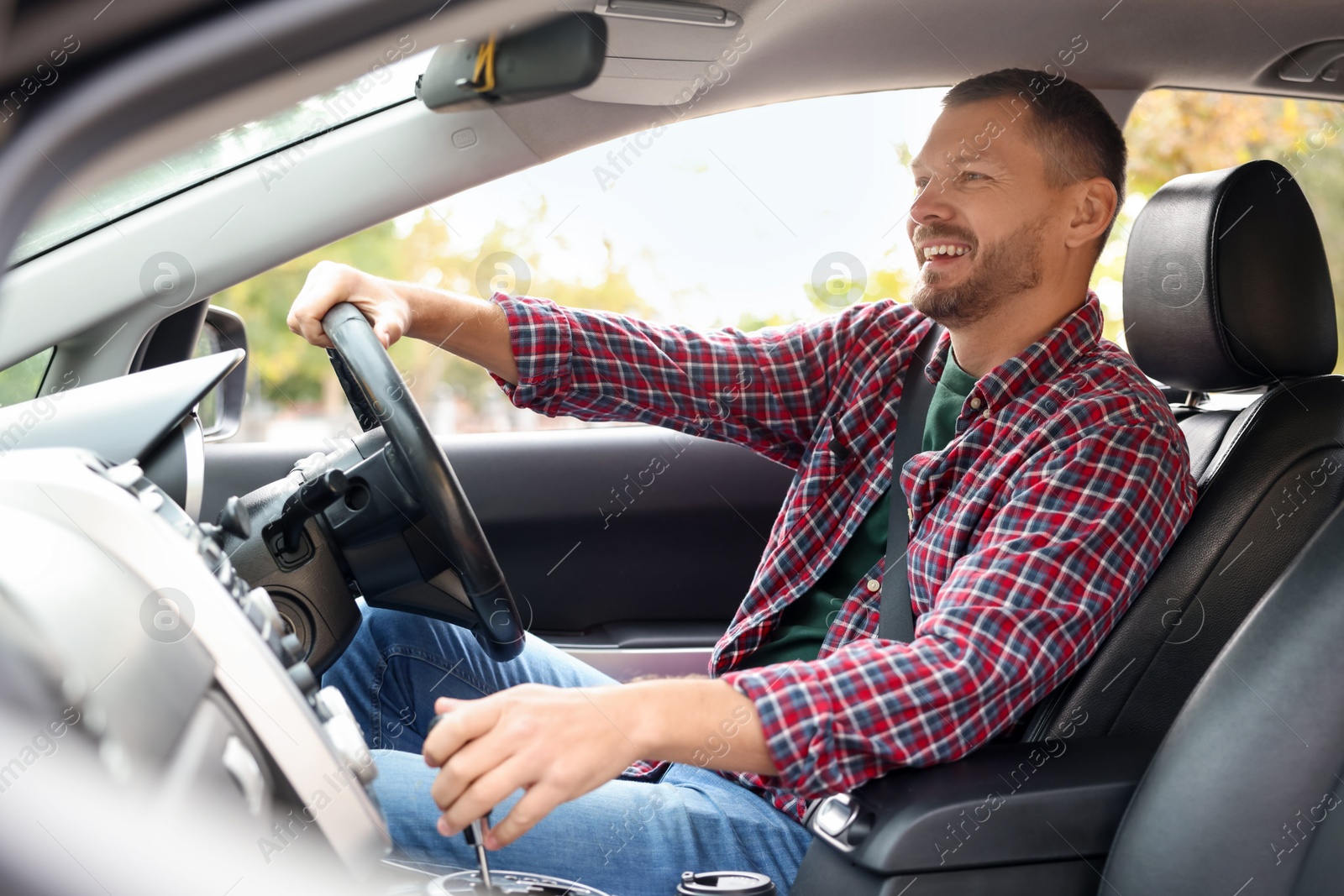 Photo of Man driving modern car, view through window