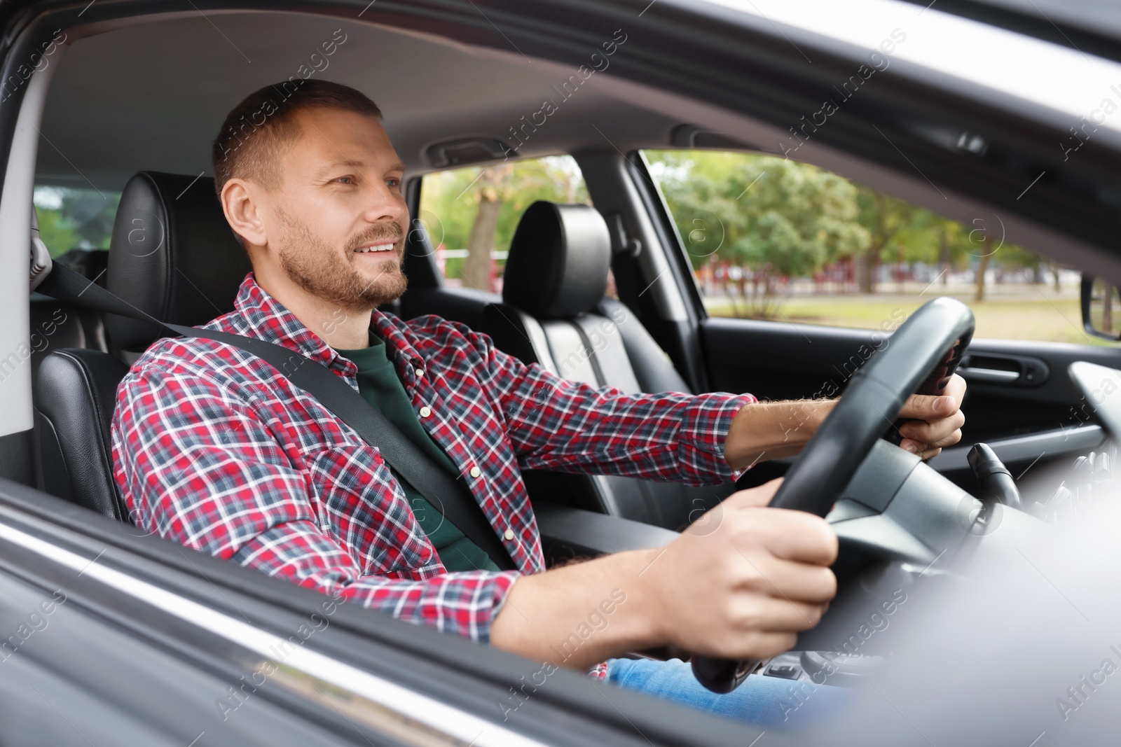 Photo of Man driving modern car, view through window