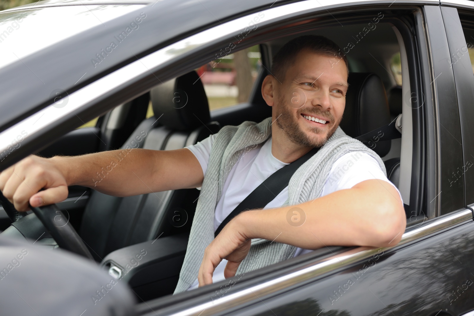 Photo of Man driving modern car, view through window